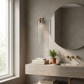 Lumira wall sconce beside a bathroom mirror